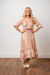 Milarose Midi Dress is a romantic and feminine piece in a vintage inspired floral print in soft rayon. Features include button front detail with elastic waist and tie, short blouse sleeves and a three tiered skirt. Style it with your favourite sandal or boot. Available from arlowboutique.com