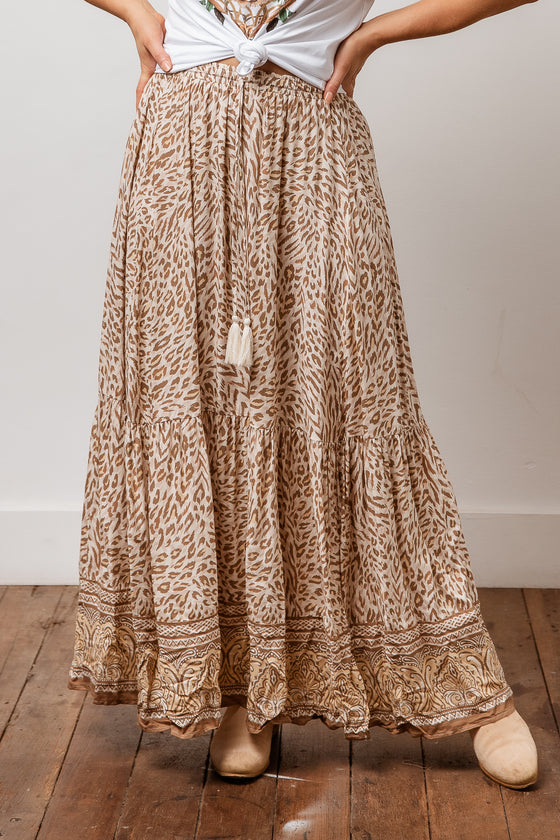 Stay effortlessly feminine in the Safari Maxi Skirt. This three tiered ankle length skirt is gathered for fullness, has a low split either side of the bottom tier, elastic waist, and a beautiful vintage inspired print with border placement at the hem. Available from www.arlowboutique.com.au