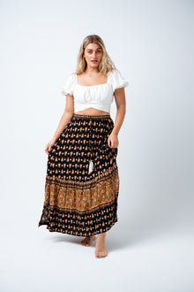  Beautiful and easy wearing, the Nina Maxi Skirt is available in a Black and Tan boho border print on super soft rayon.  Featuring an ankle length skirt with elastic waistband, tie & tassel trim and a single tiered gather hem and front split. Perfect to style with a print tee for a simple but striking day look. Available from www.arlowboutique.com