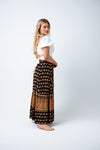 Beautiful and easy wearing, the Nina Maxi Skirt is available in a Black and Tan boho border print on super soft rayon. Featuring an ankle length skirt with elastic waistband, tie & tassel trim and a single tiered gather hem and front split. Perfect to style with a print tee for a simple but striking day look. Available from www.arlowboutique.com