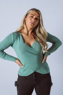  The Trudi Knit Top is made from a fine rib knit fabric, featuring a cross over front, long sleeves and an asymmetric hemline. A fantastic transeasonal piece that you will be going back to year after year.  Available in 4 colours.