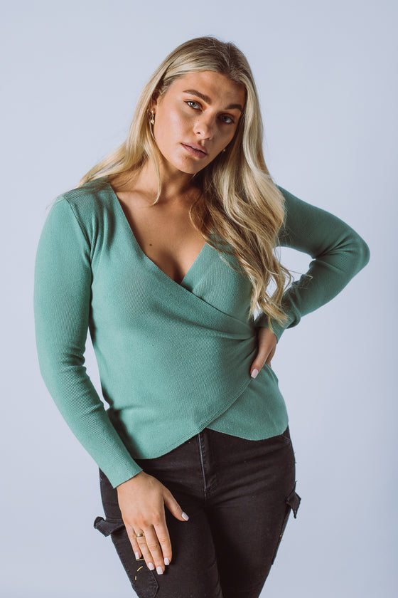 The Trudi Knit Top is made from a fine rib knit fabric, featuring a cross over front, long sleeves and an asymmetric hemline. A fantastic transeasonal piece that you will be going back to year after year.  Available in 4 colours.