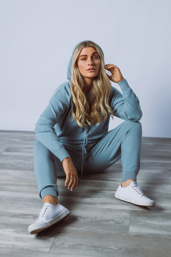 Your go-to lounge wear set! Lockdown or not, we all love a tracksuit set. The Carley Set is available in soft knit fabric and features a simple hoodie pullover upper with drawstrings and drop shoulder sleeves, and a slim fit jogger style lower, with rib bands and drawstring waist.   Also available in Black