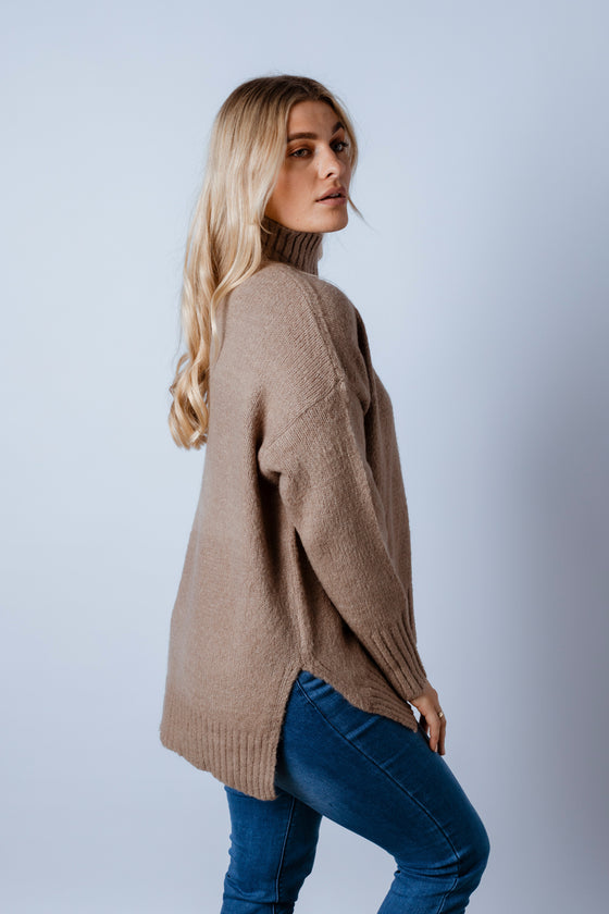 Stay cosy in the Akira Knit Jumper! Featuring a stand collar, long body length in a loose fit and a scoop hemline with side splits. An effortless cool piece, fall in love with all six colours.Available from Arlow boutique